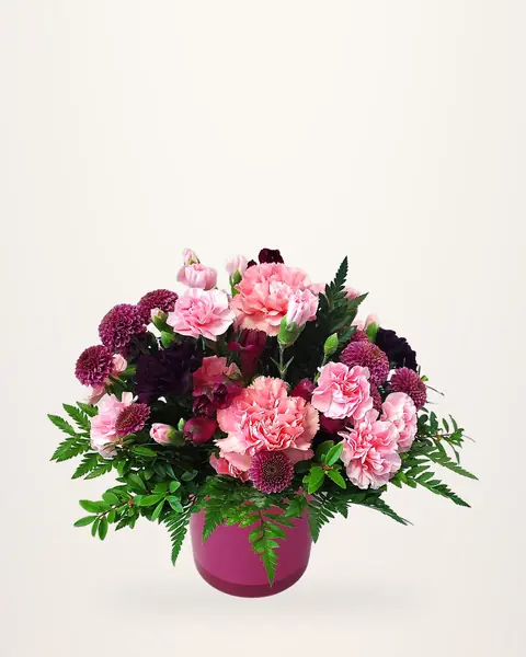 Pink carnation and dahlia arrangement in a pink pot